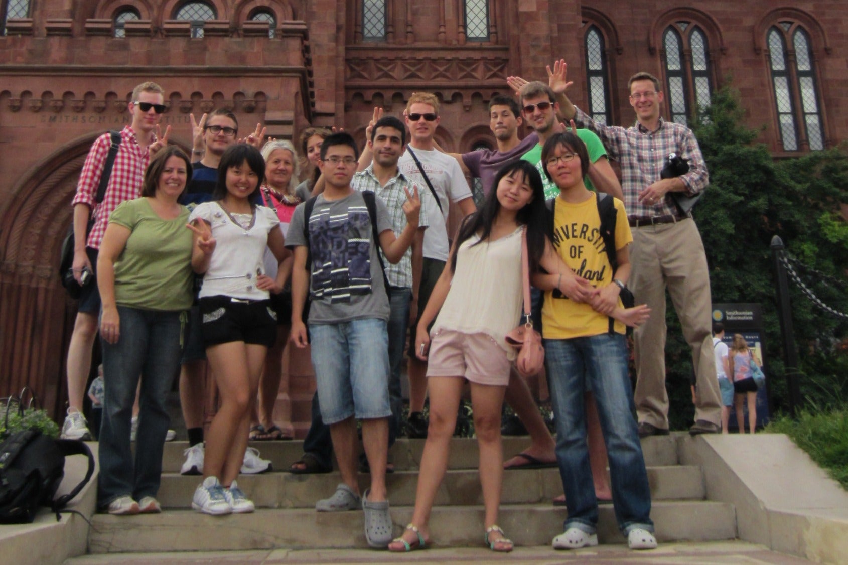International students pose in front of the Smithsonian.
