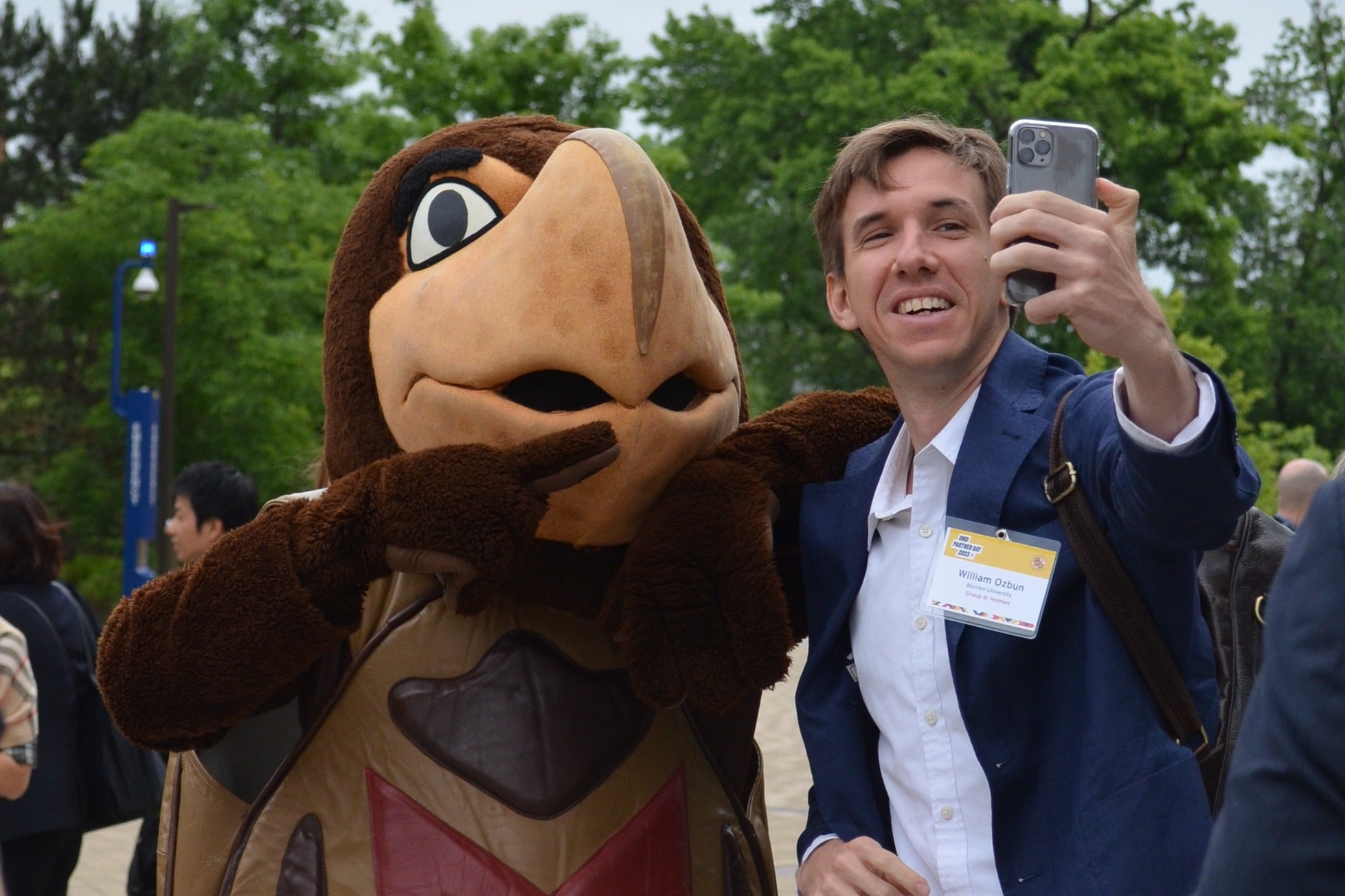 Testudo poses for a selfie with a man.