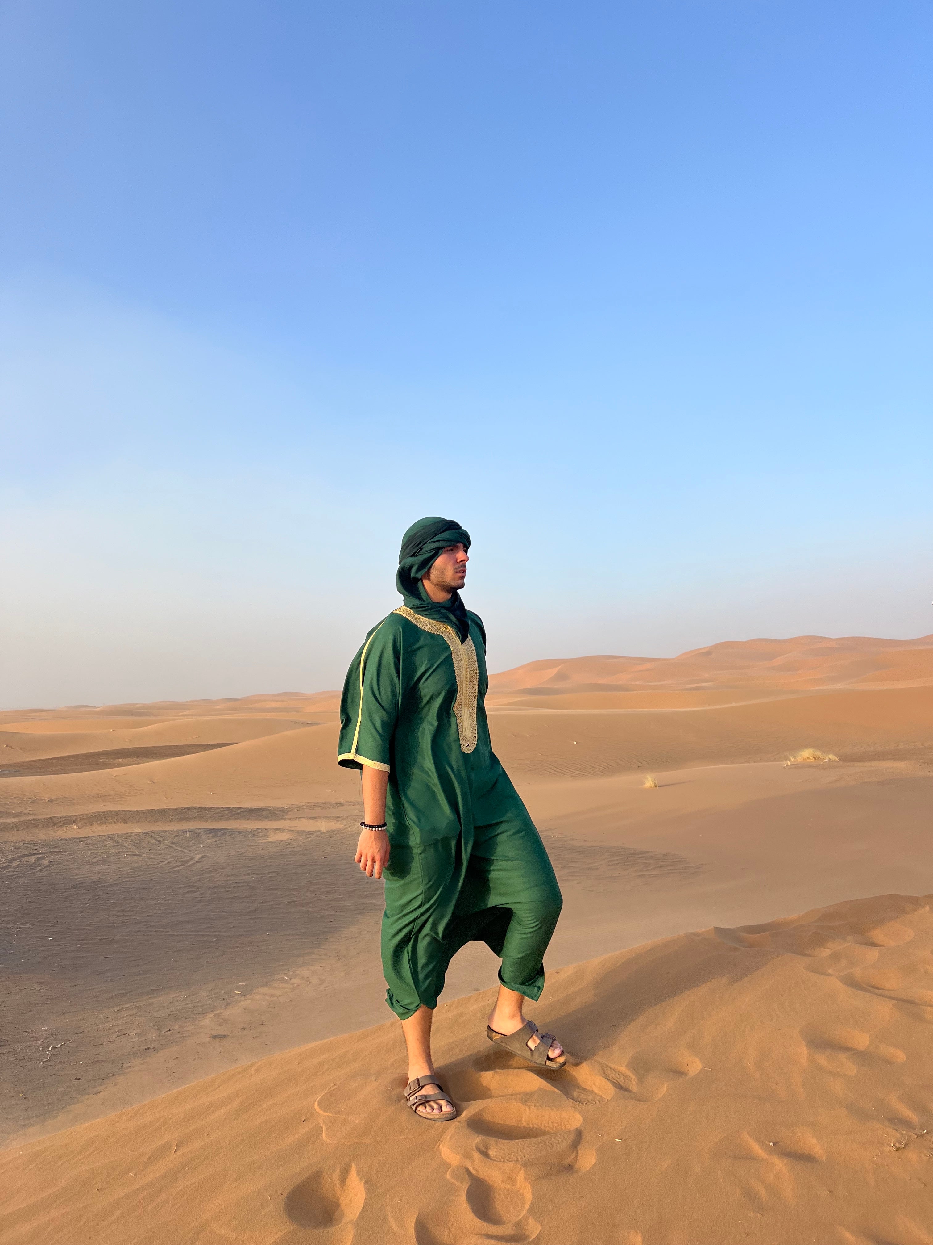 Man stands on the dunes of the desert