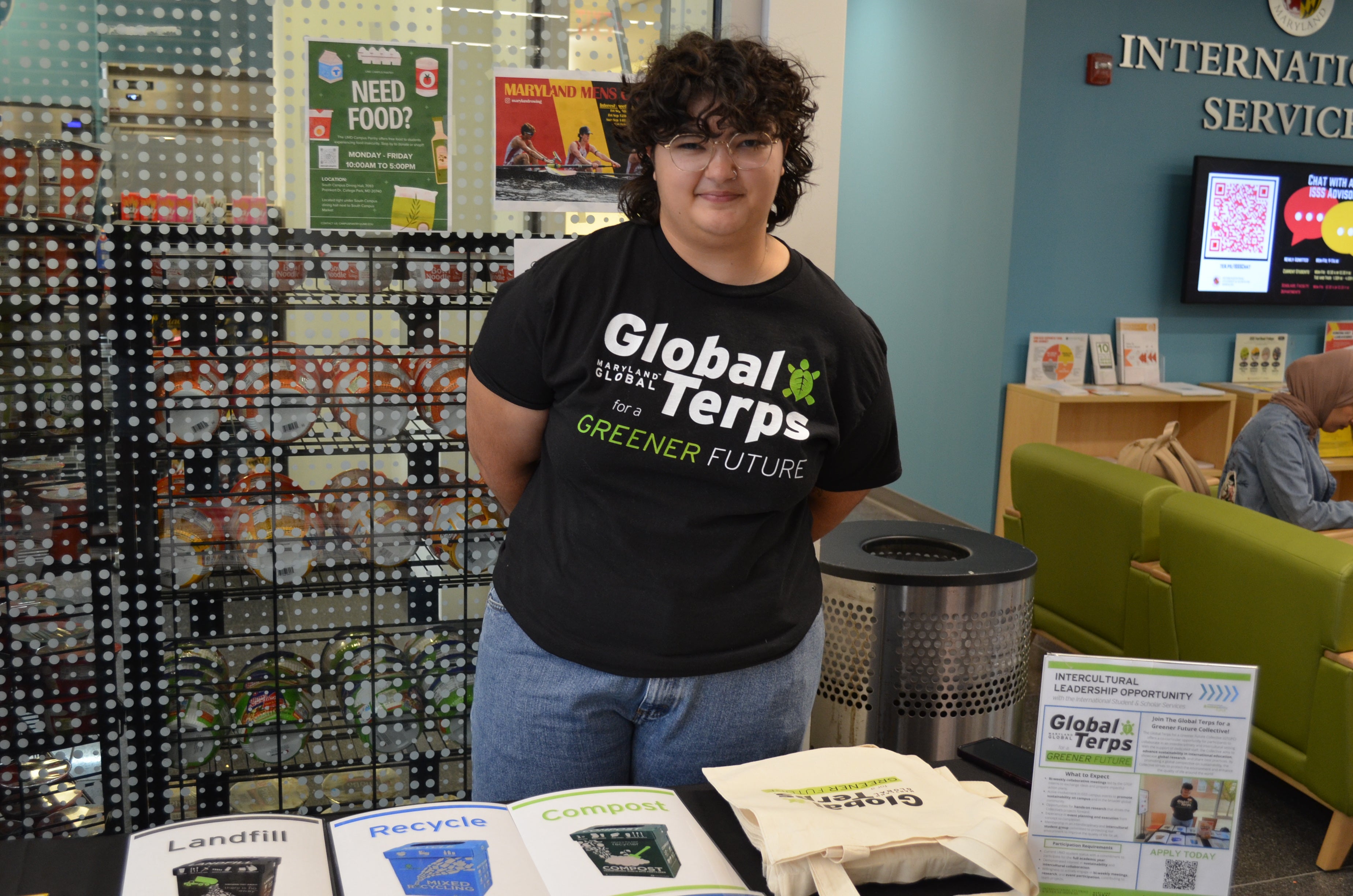 Abigail Vanasse wearing a Global Terps for a Greener Future shirt and tabling 