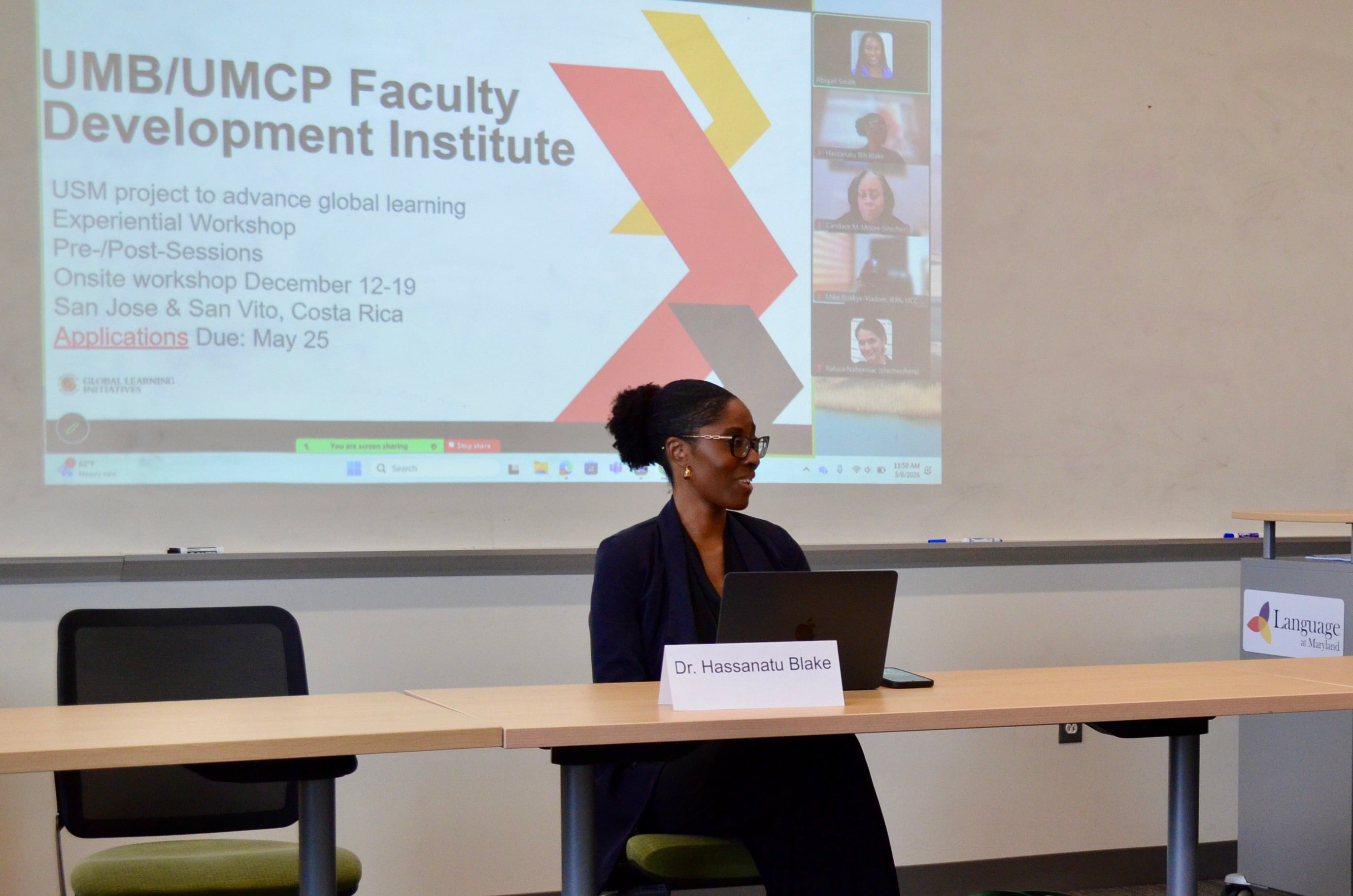 Dr. Hassanatu Blake speaks to a classroom in front of presentation slides and virtual attendees
