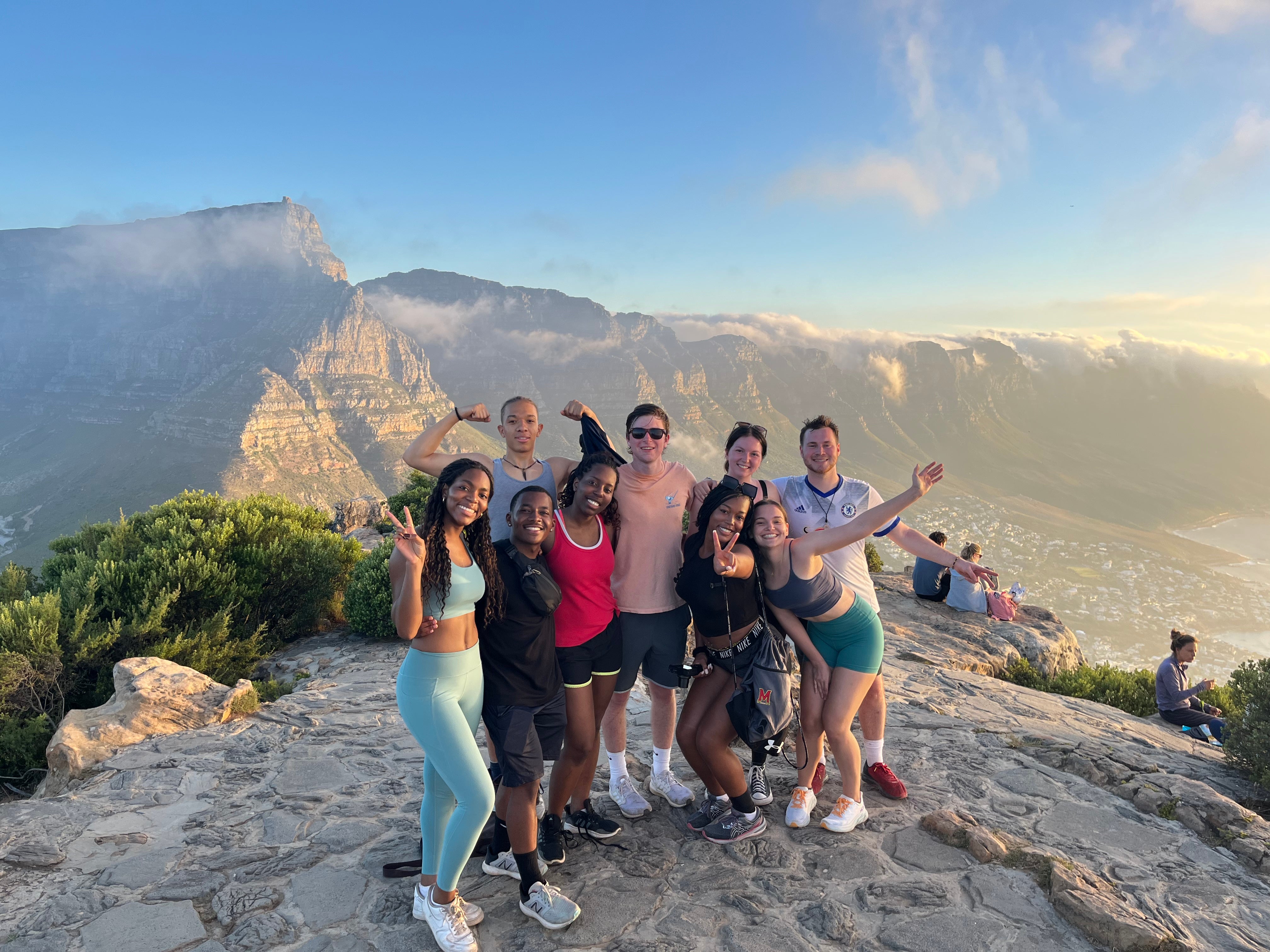 A group of UMD stand at the summit of Lion's Head Mountain in Cape Town, South Africa after hiking to the top.