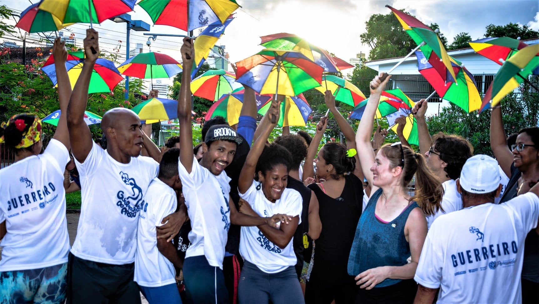 Kate Spanos twirling colorful umbrellas with dancers in Recife, Brazil