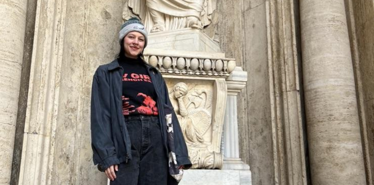 Alexys Lopez poses in front of a statue in Italy. 