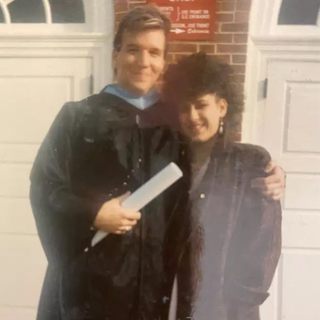 Ken Baron in graduation gown with a woman