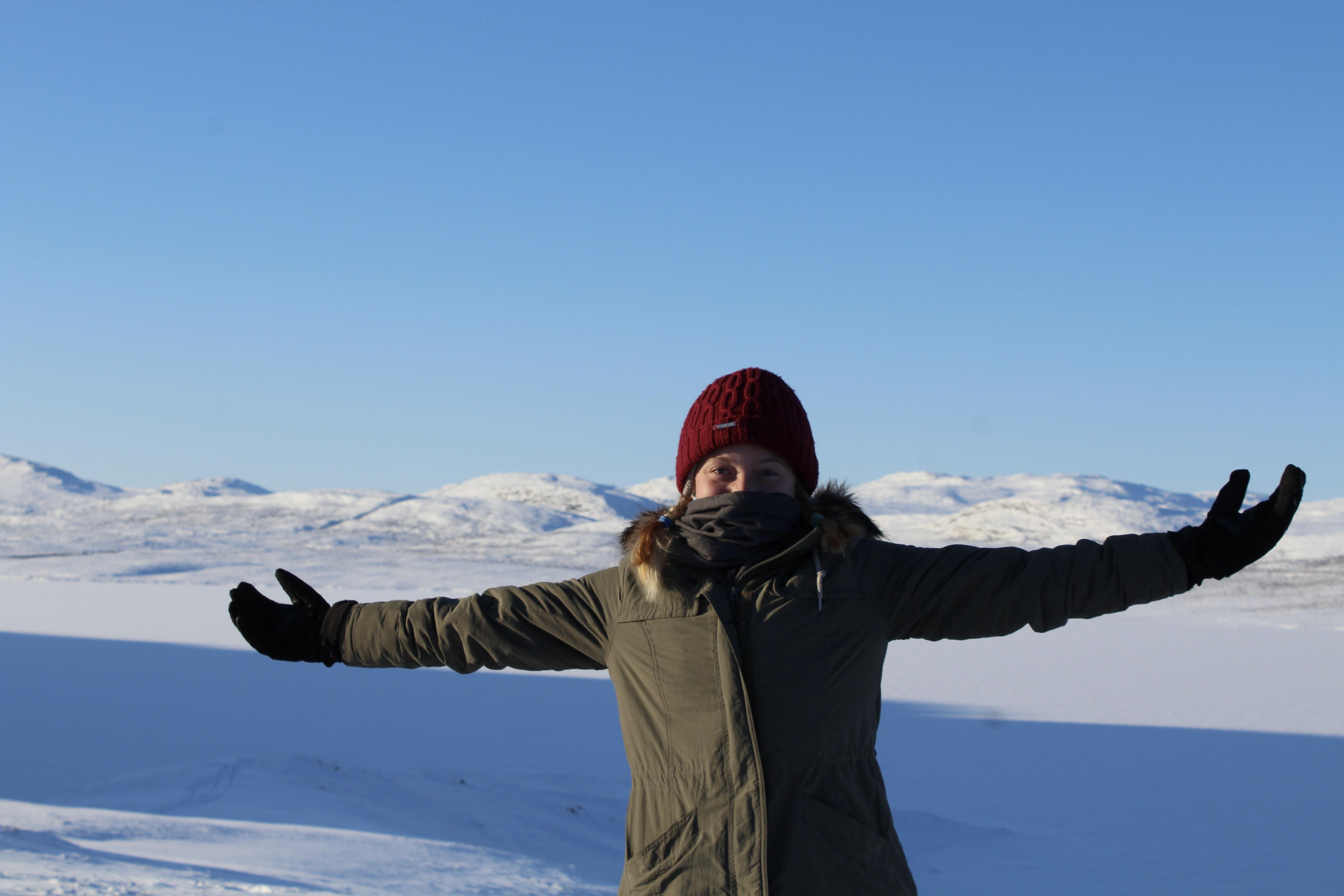 Student poses on a frozen tundra on exchange in Norway. 