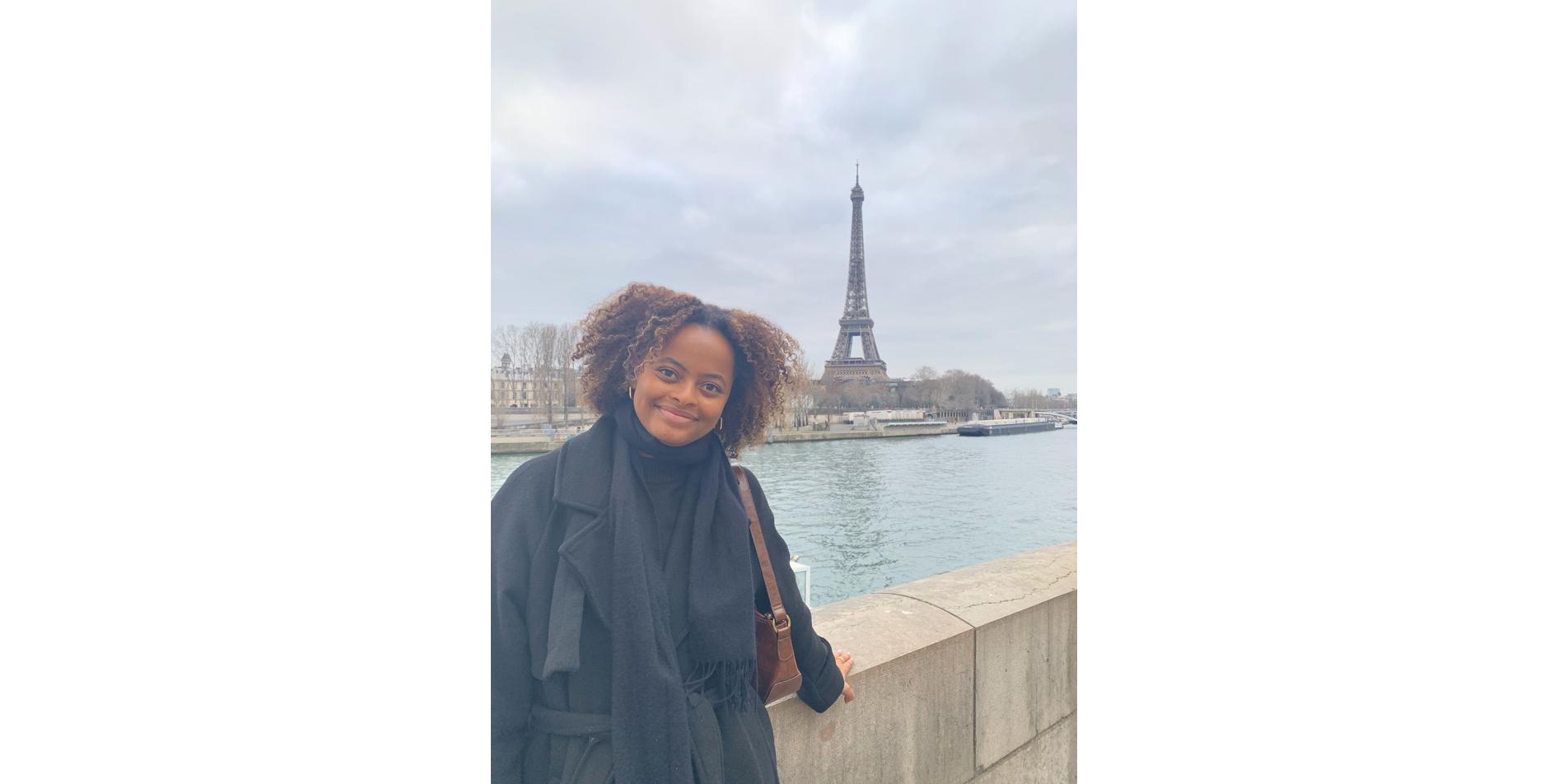 Sophia Wooden '24 poses in front of the Eiffel Tower in Paris, France.
