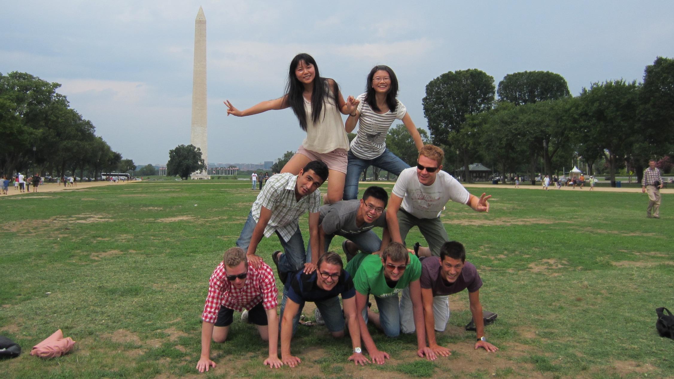 Students form a human pyramid in front of the Washington Monument.