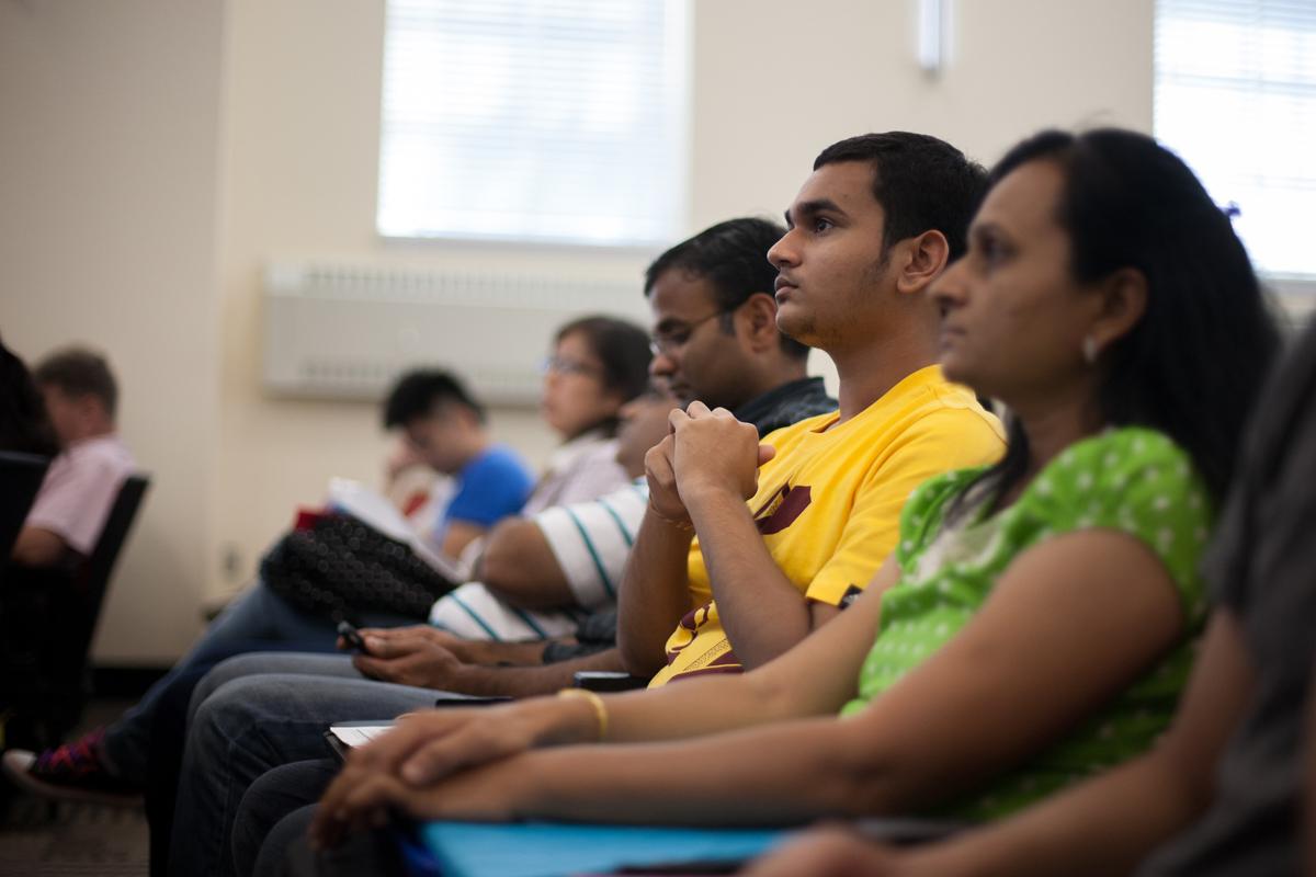 Students sit together in an auditorium. 