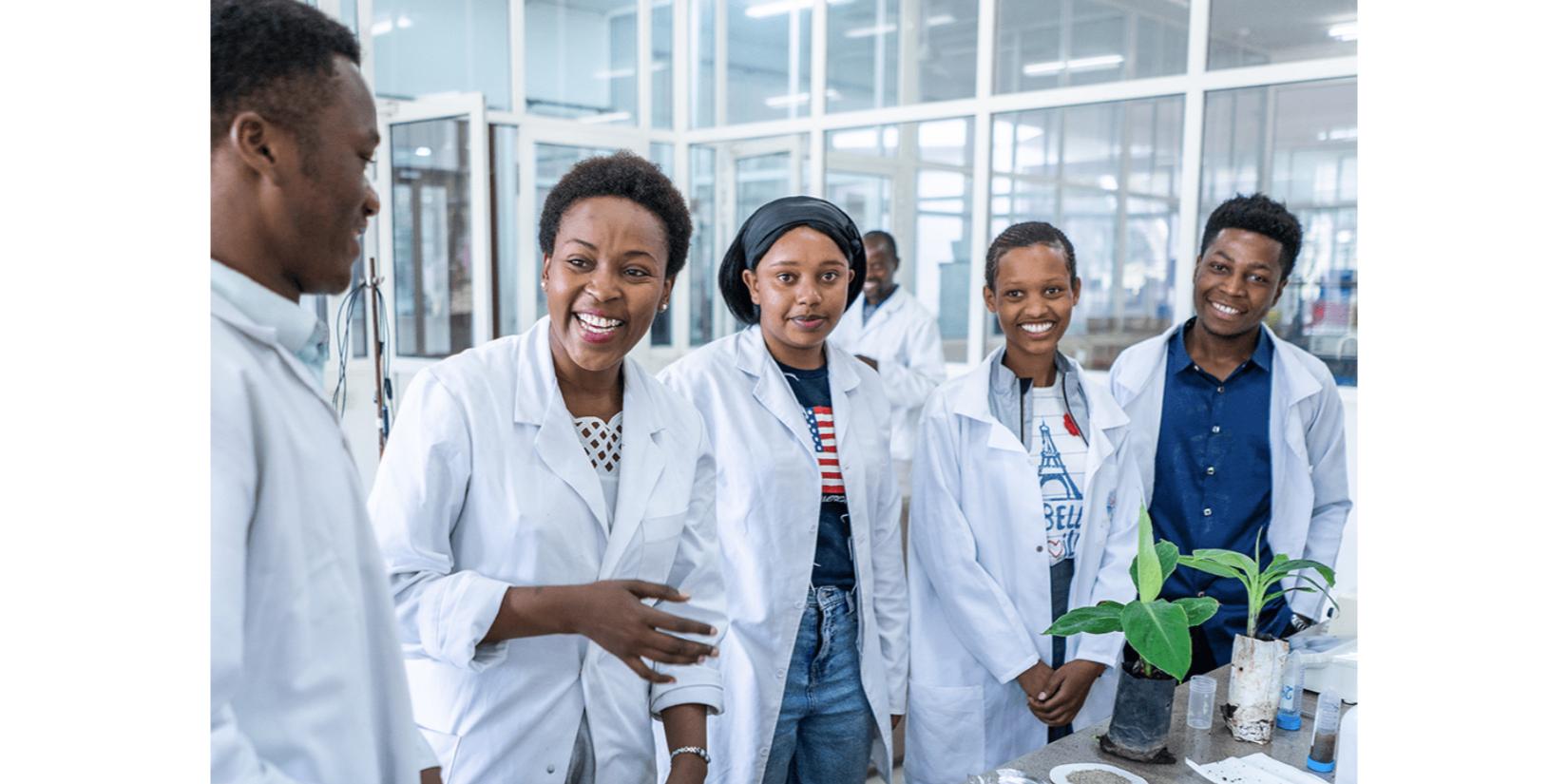 A group of students poses together in a laboratory. 