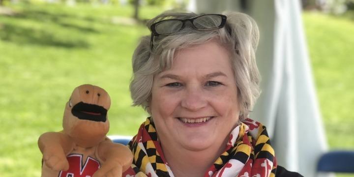 Jody Heckman-Bose poses with a stuffed animal Testudo.