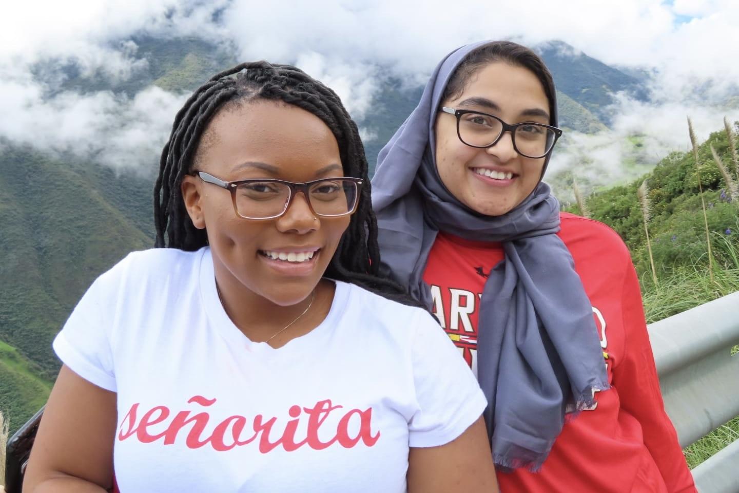 Two UMD students smile at a scenic viewpoint. 