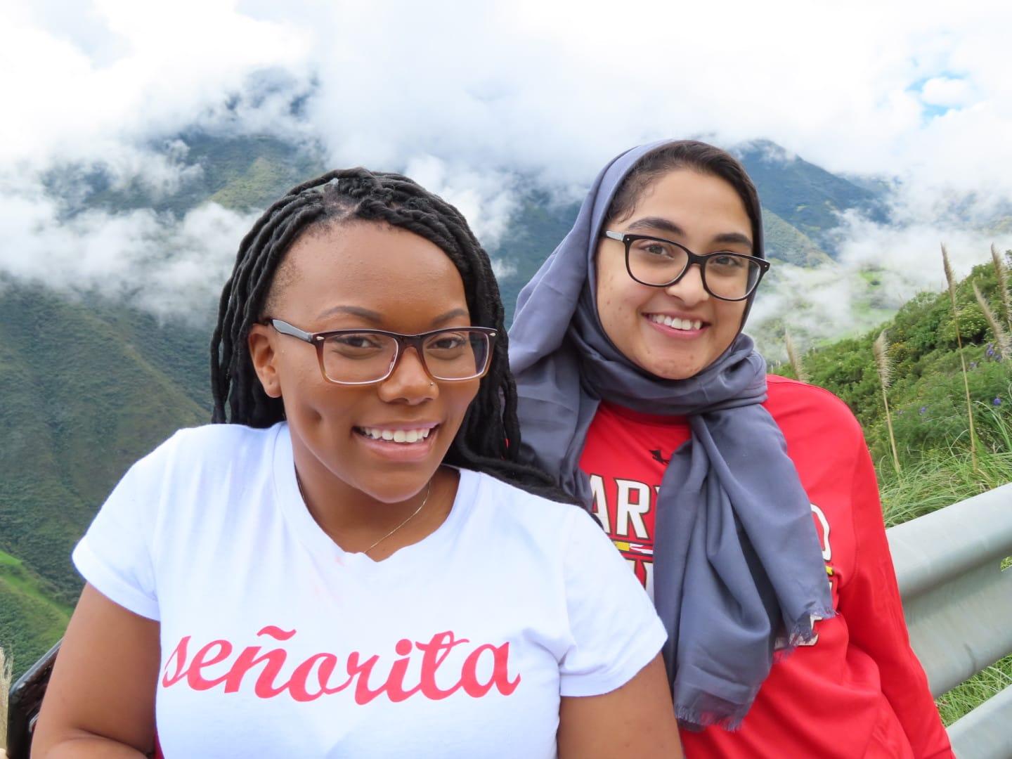 Students pose on a mountaintop.