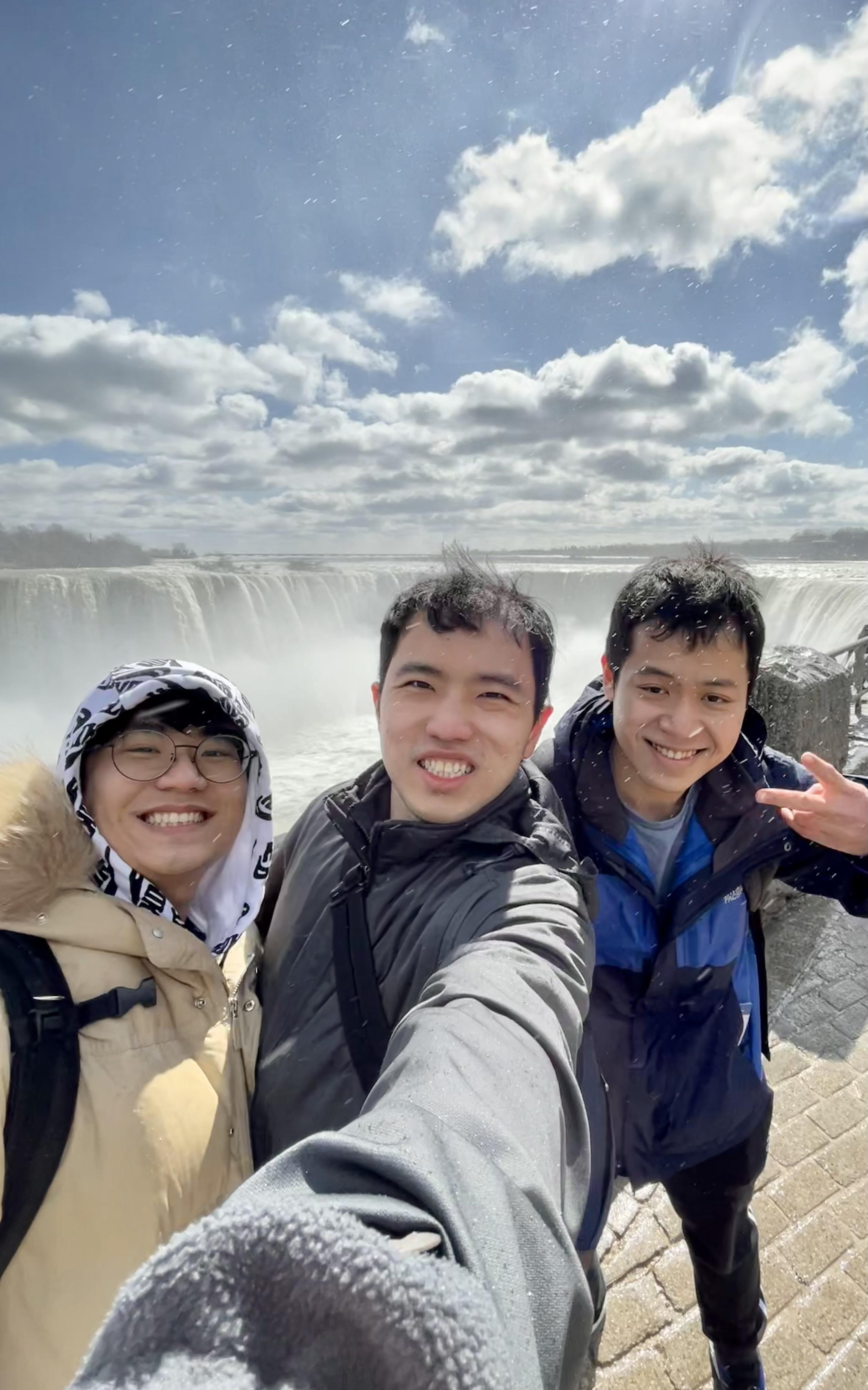Three students pose in front of Niagara Falls. 