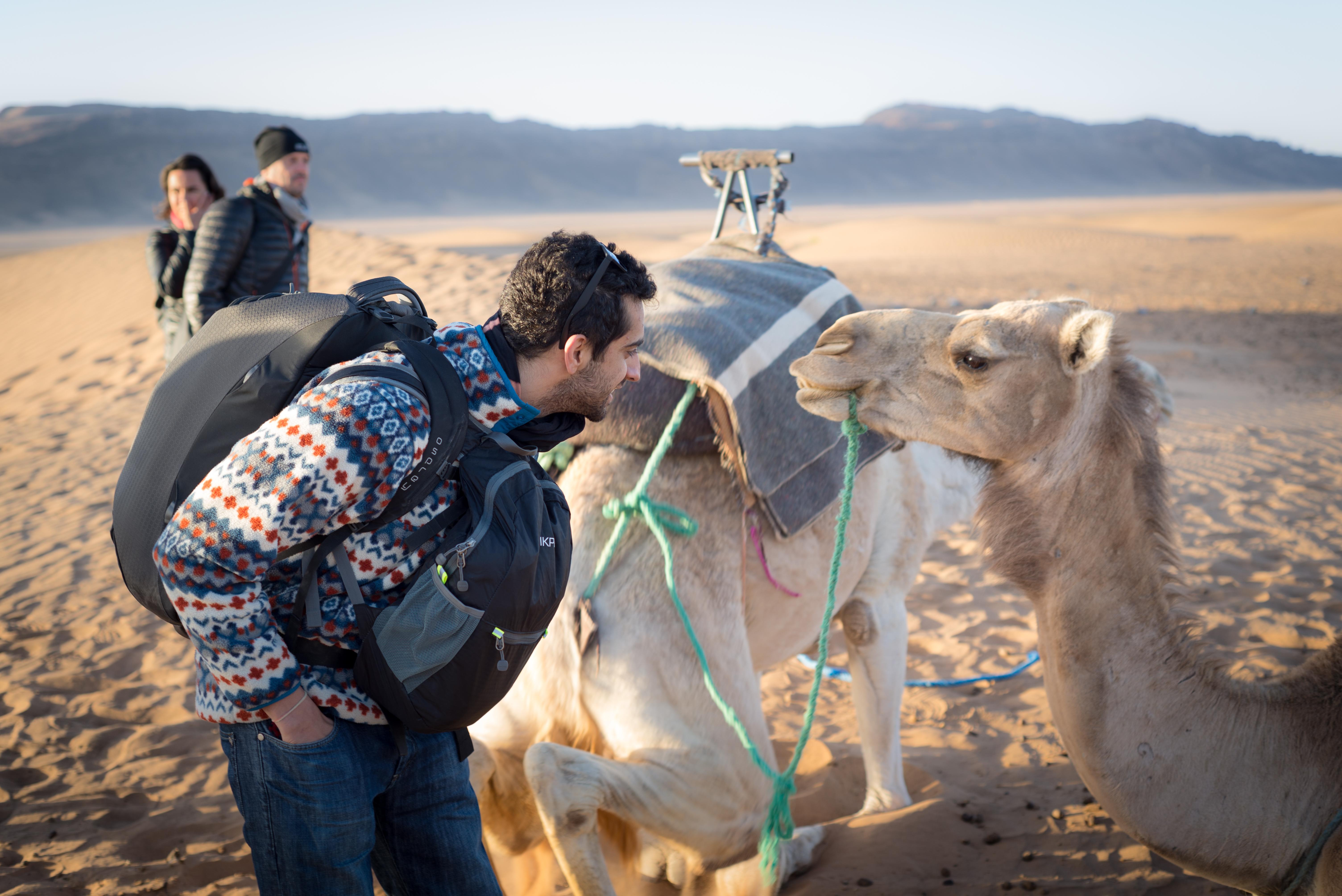 Student poses with a camel.