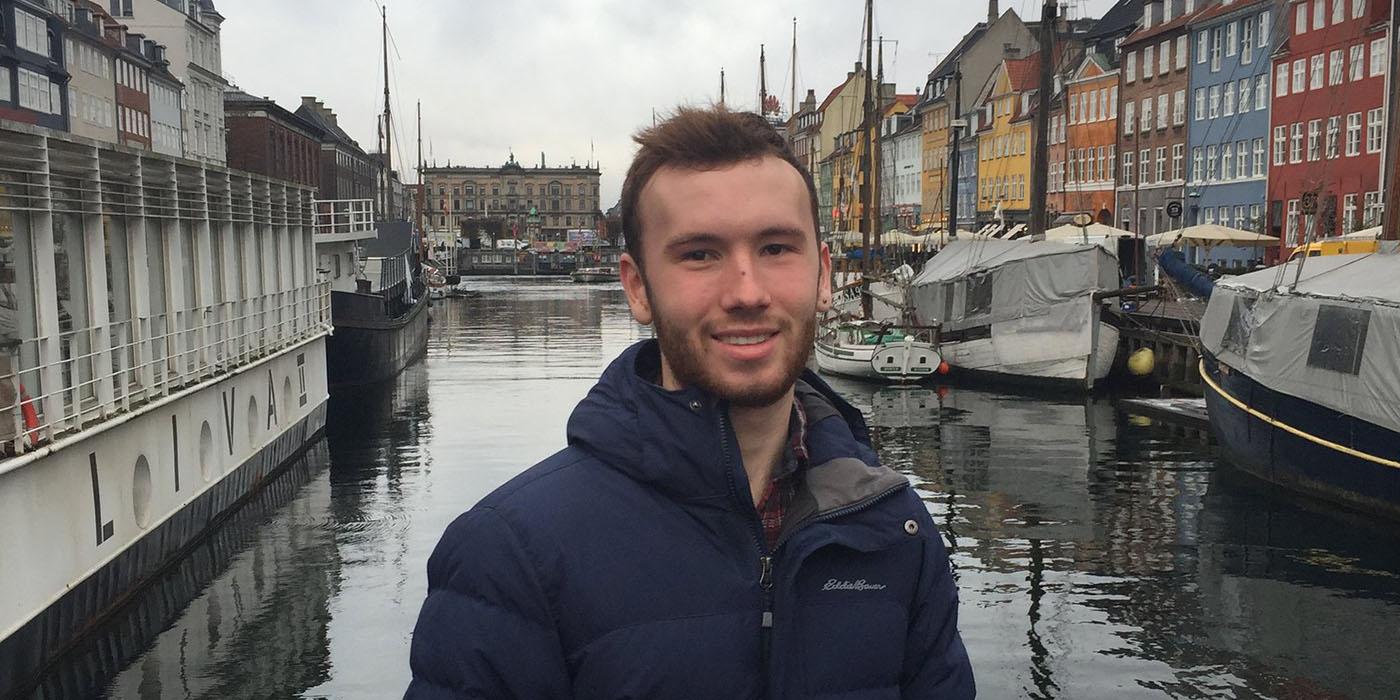 Ben standing in front of a canal in Copenhagen