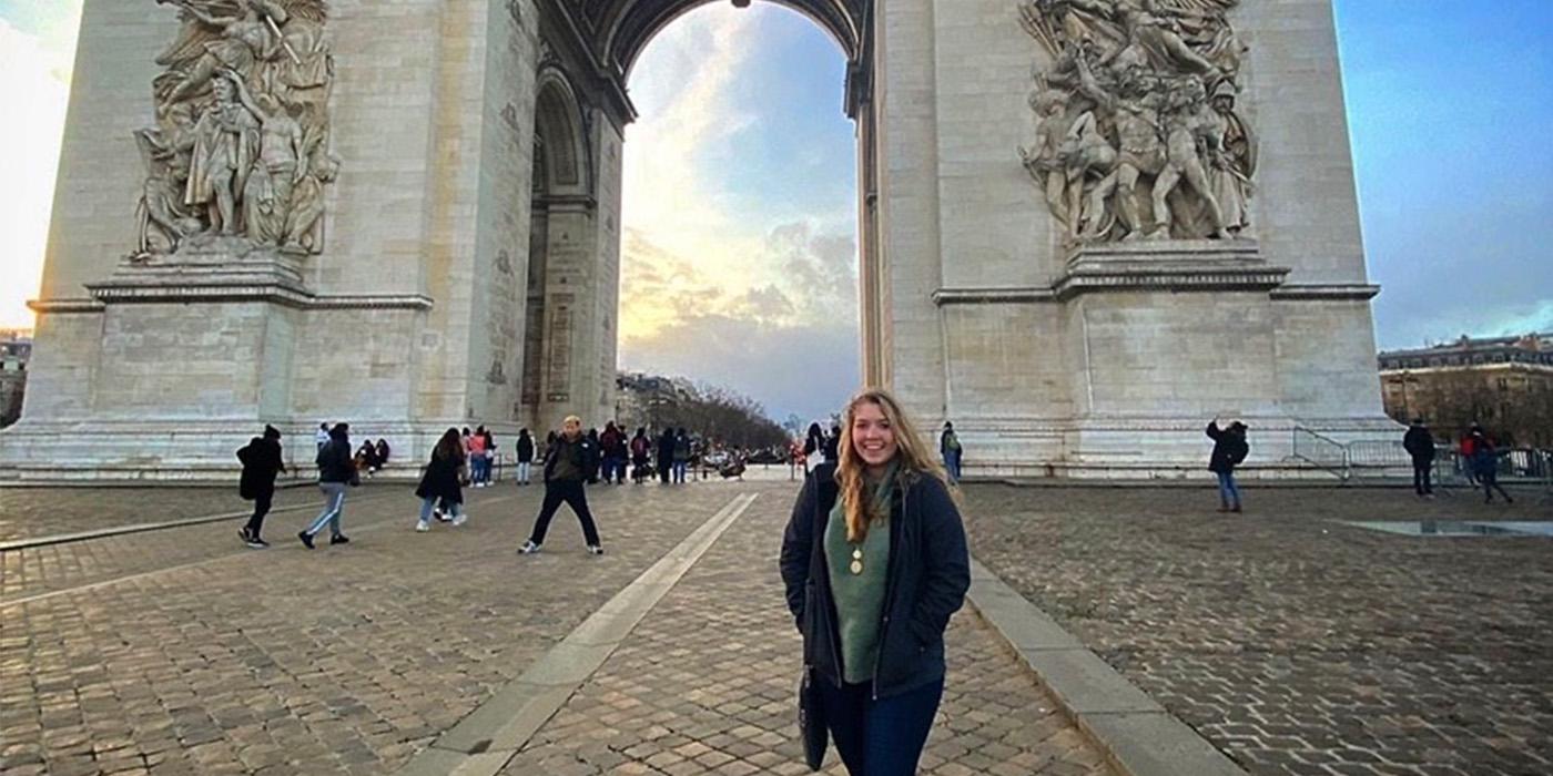 Caitlin McPartland stands in front of the Arc de Triomphe in Paris