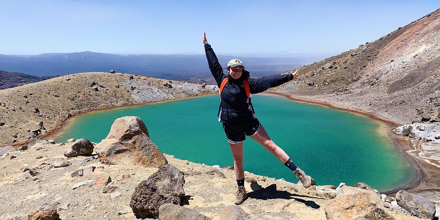 Chelsea Dinneny arms wide in front of a sulfur pool