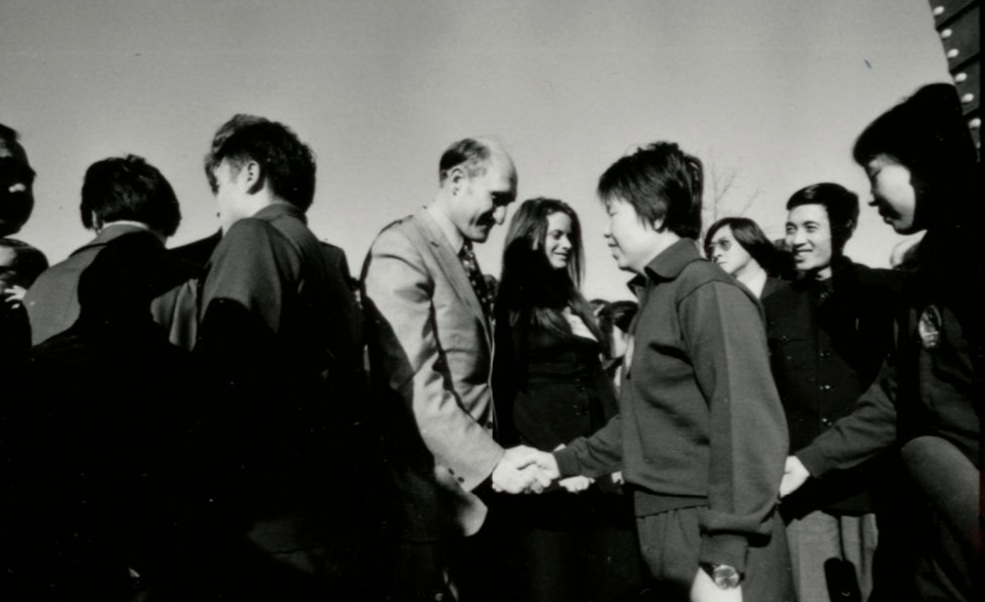 UMD and Chinese representatives shake hands after a diplomacy ping-pong match, circa 1972.