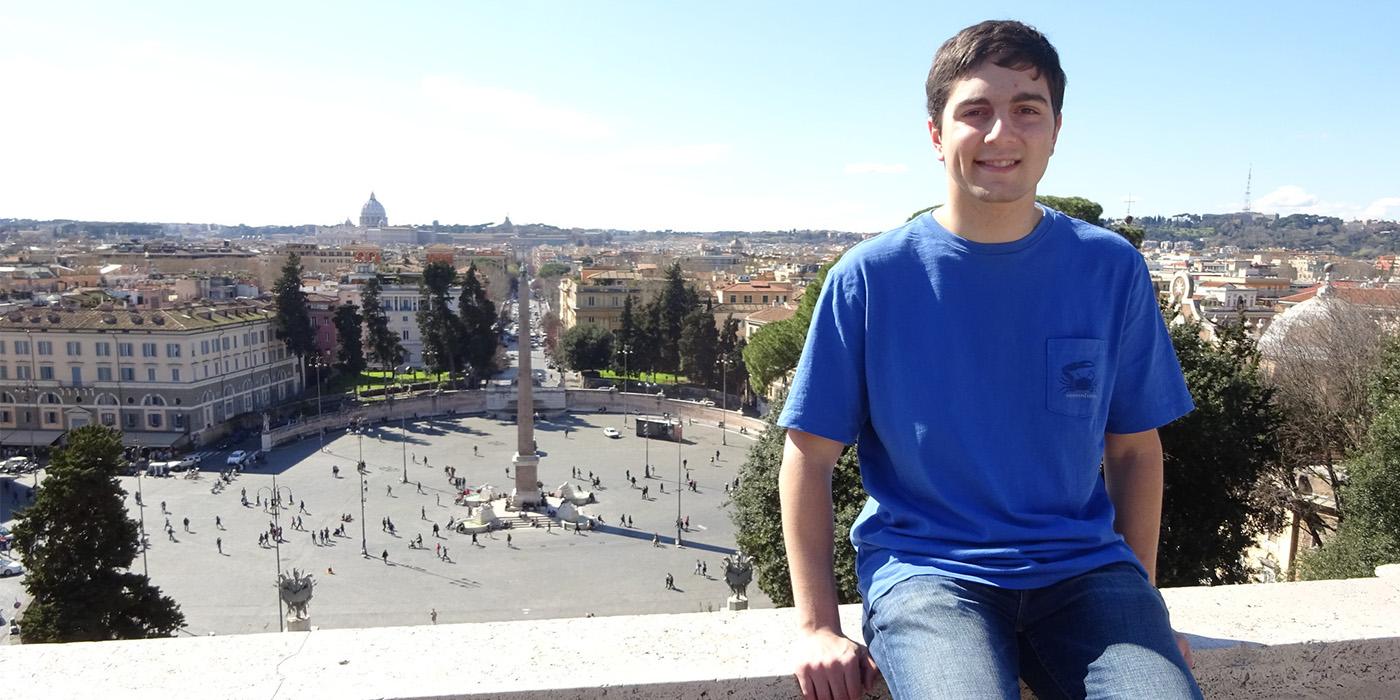 Dan sitting on a ledge overlooking the Piazza del Popolo