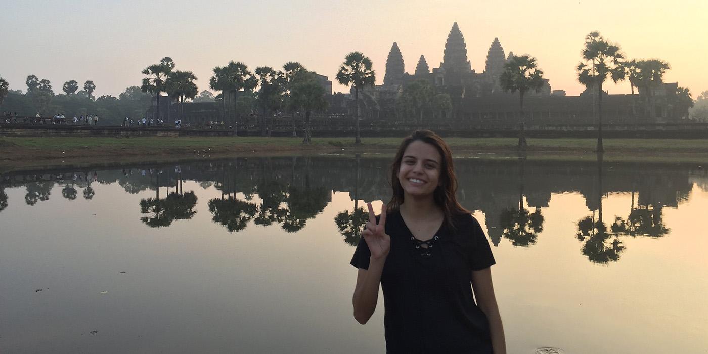 Jessica standing in front of the Angkor Wat temple in Cambodia 