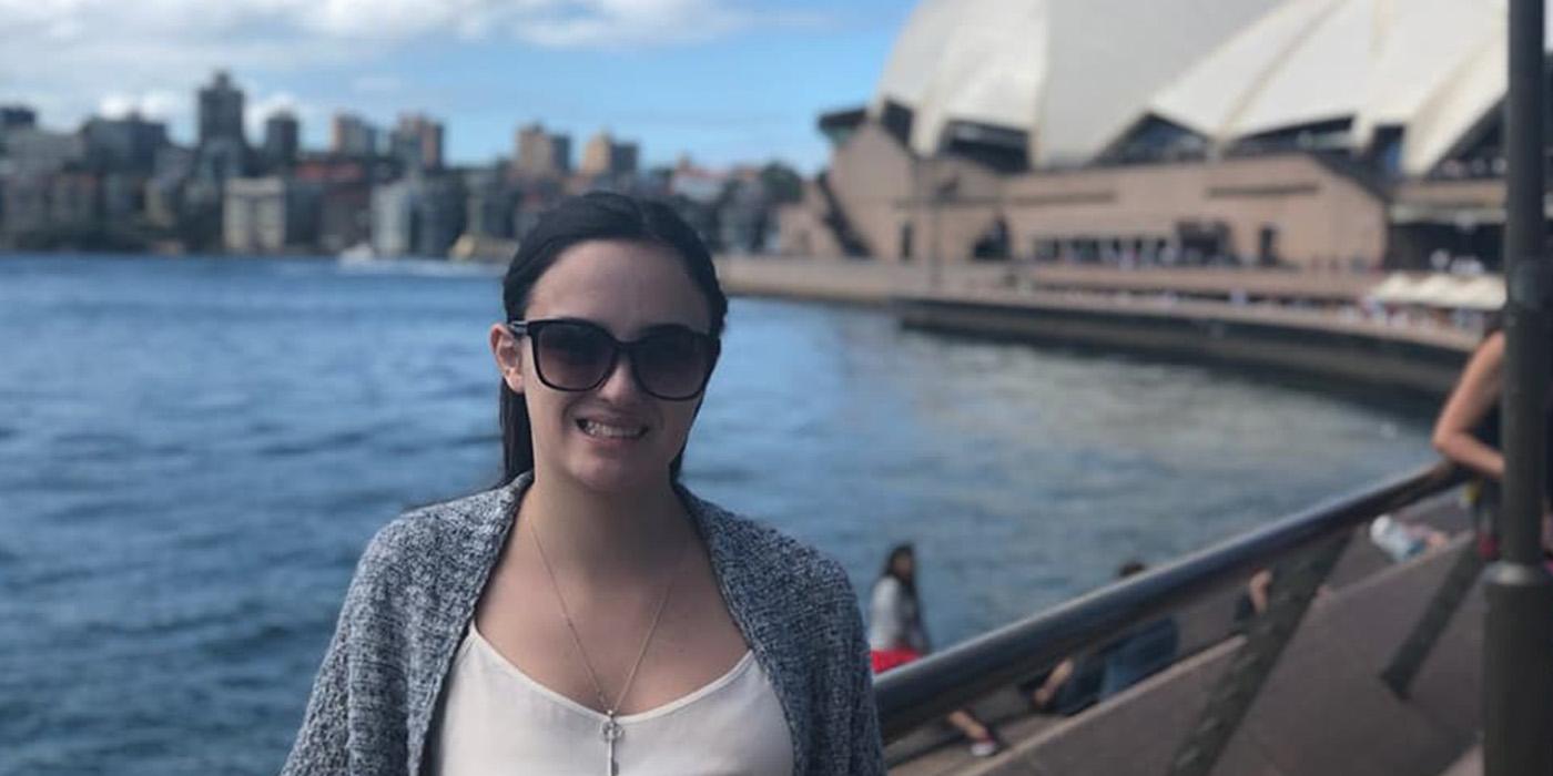 Juiana standing in front of the Sydney Harbour and Sydney Opera House