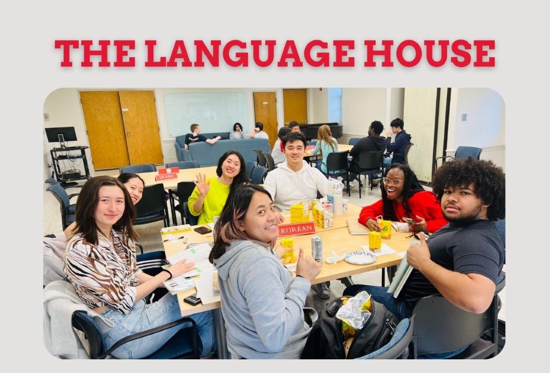 Seven students sitting at a table during the Language Chat session at the Language House.