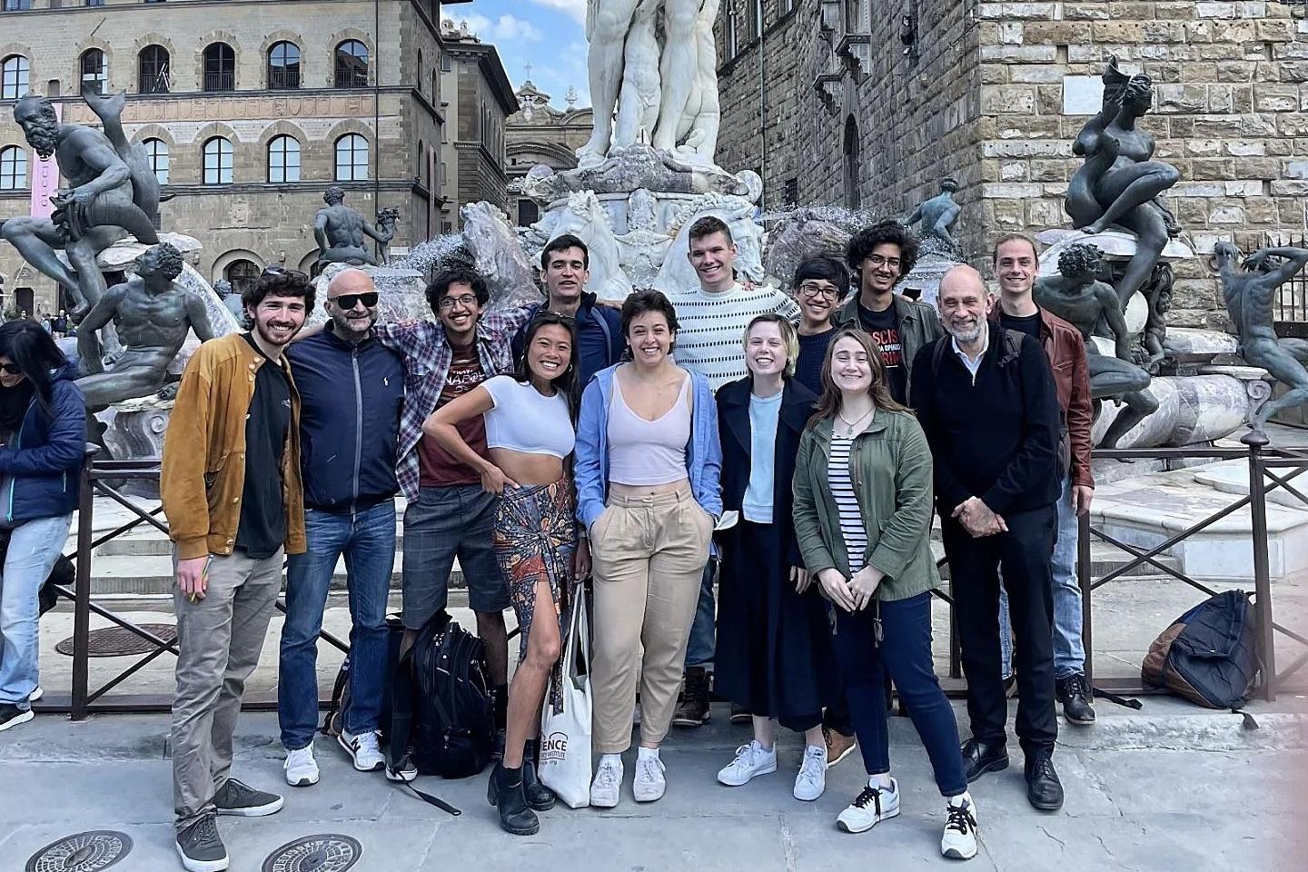 Students from Maryland-in-Florence (PHYS) stand with their professor in a piazza.