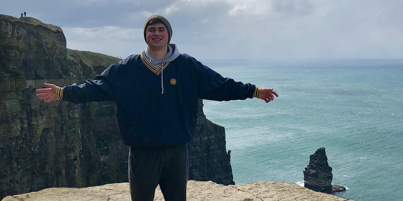 Mitch standing in front of the Cliffs of Moher in Ireland