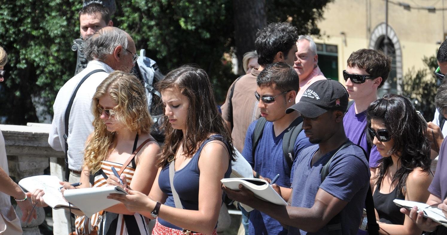A group of student taking notes outside