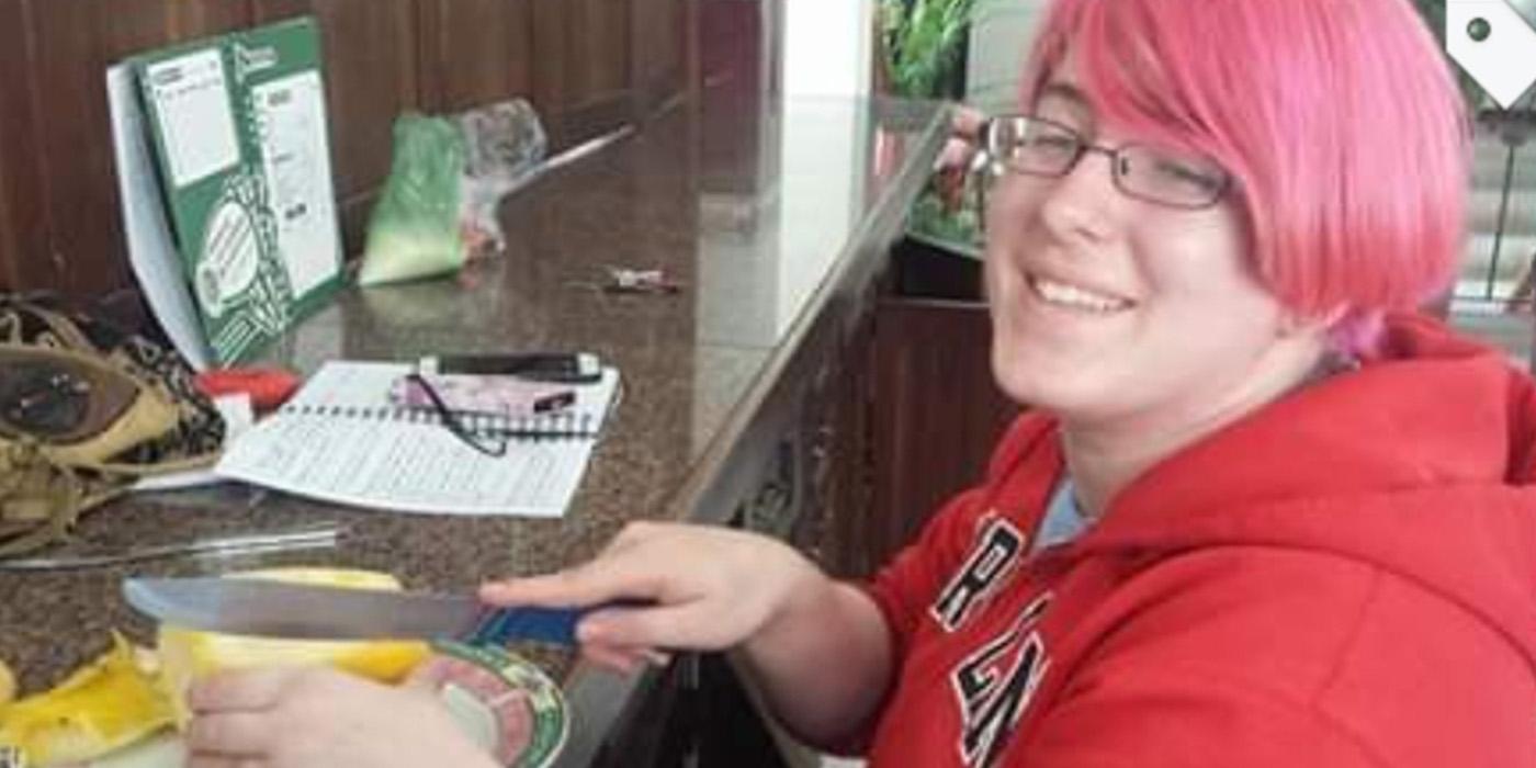 Teressa smiling while preparing a meal at a counter. 