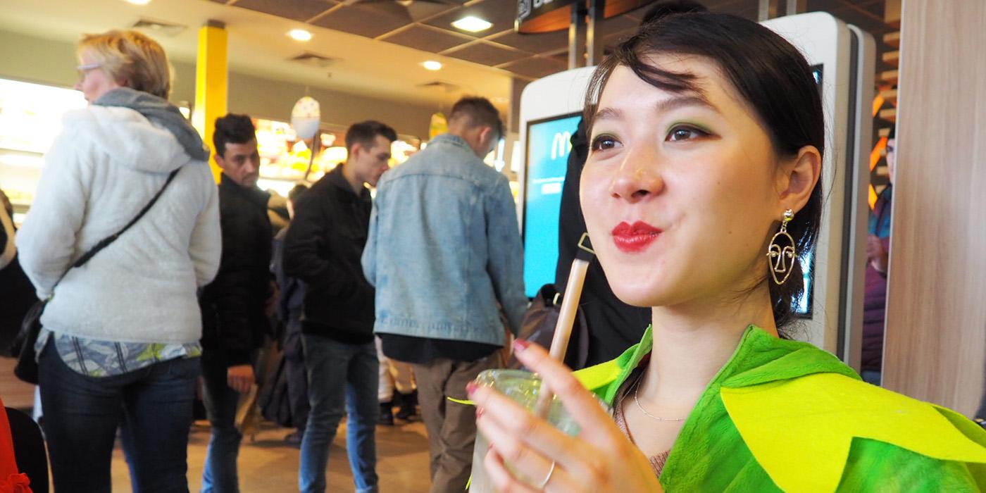 Viven Zhu in a market drinking a beverage