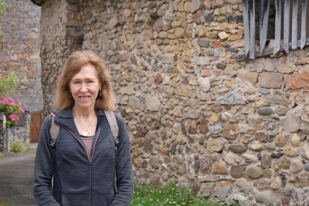 Dr. Valerie Orlando poses in front of a stone cottage during her Fulbright in France. 