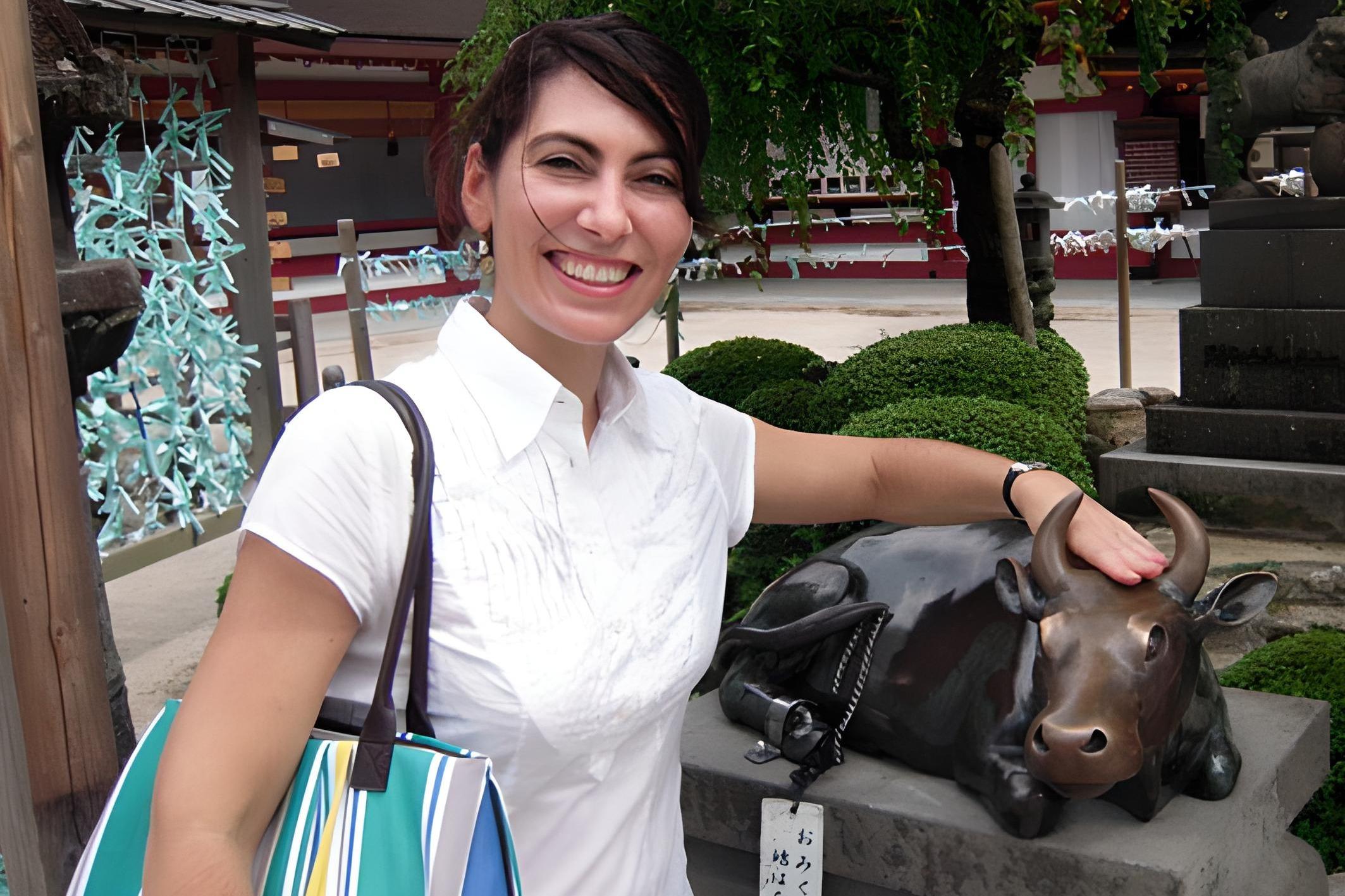 Dr. Alicia Volk poses with a cow statue during her Fulbright in Japan.