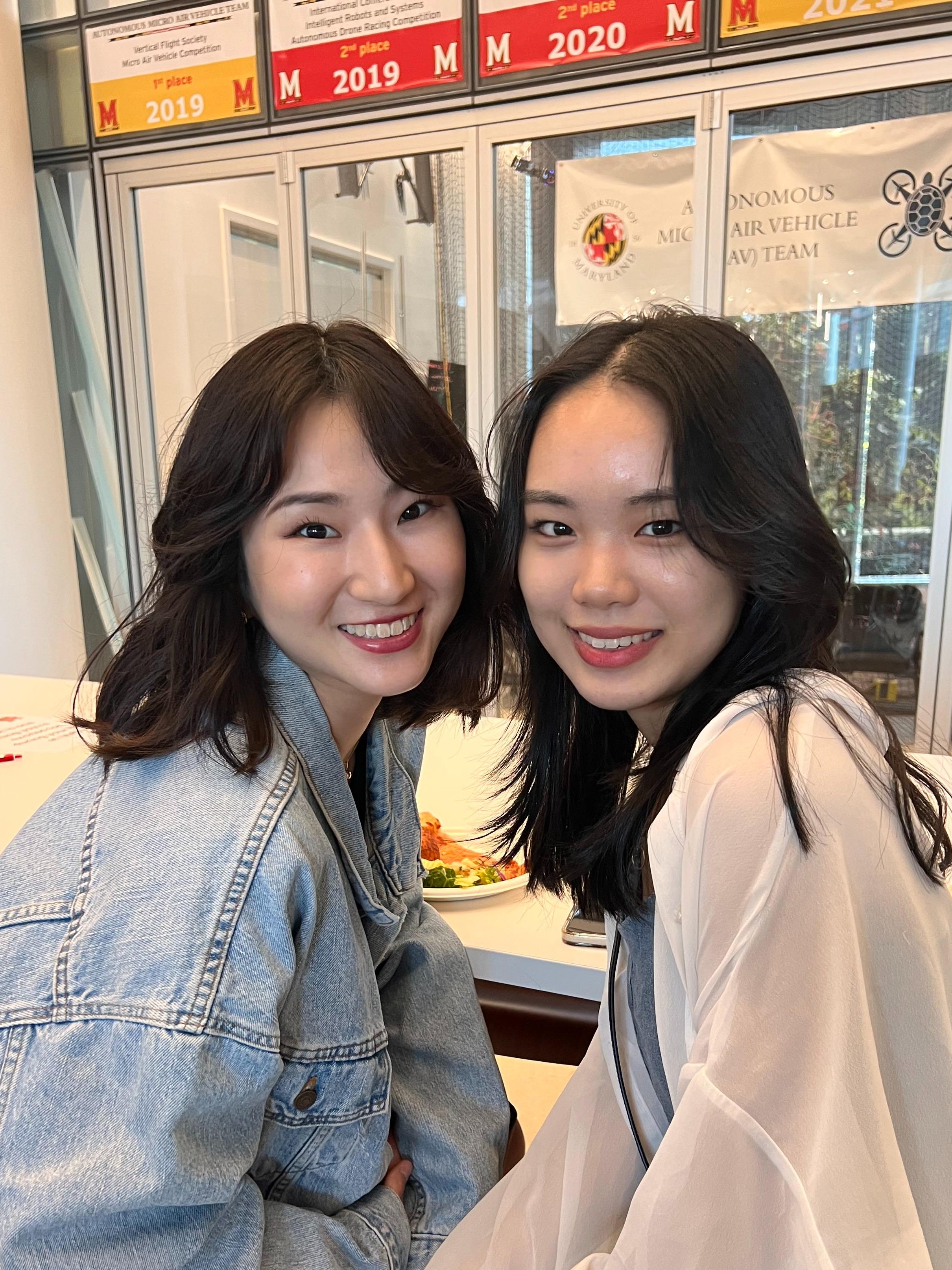 Two international students pose together.