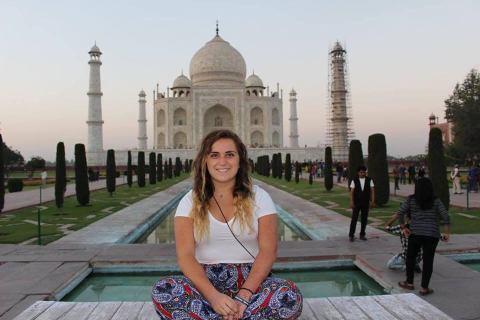 Student poses outside of the Taj Mahal.