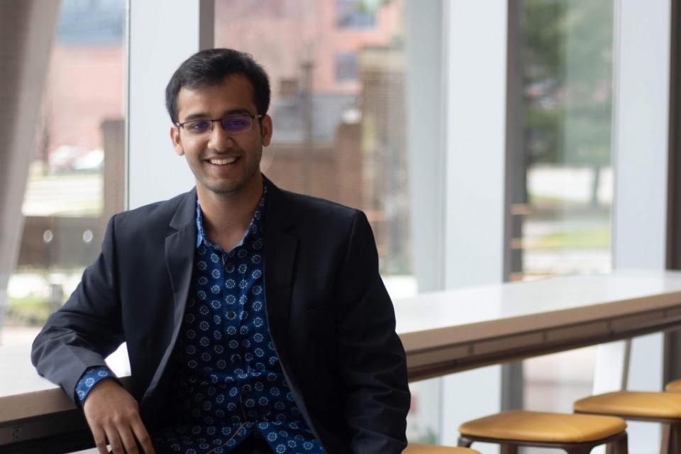 Kislay Parashar poses on a stool.