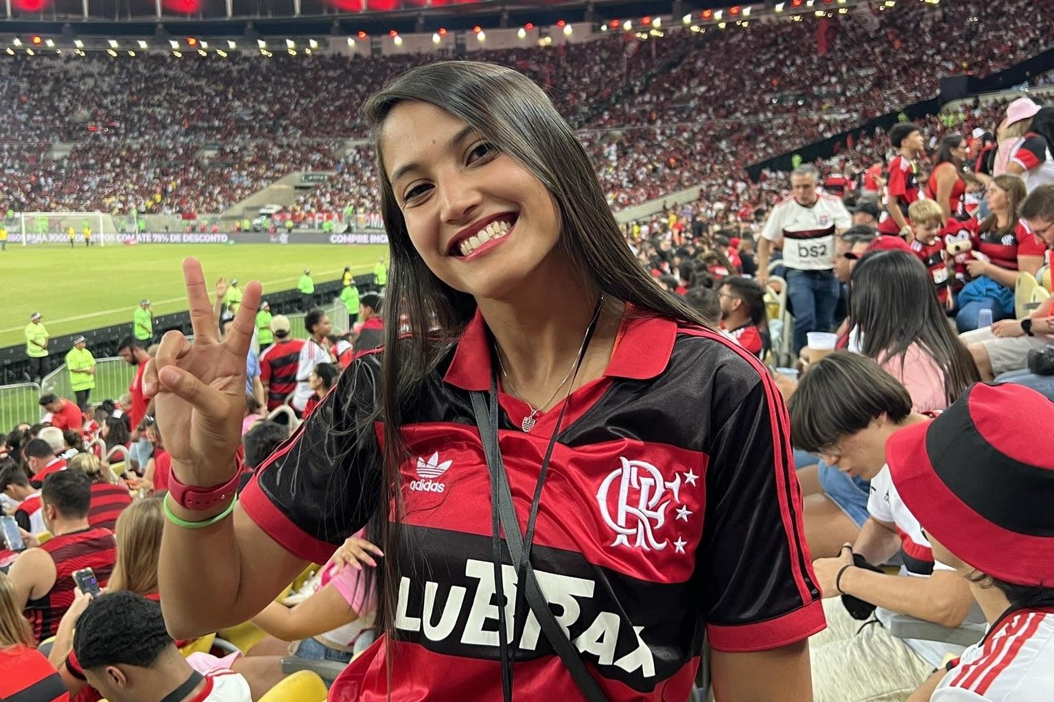 Flavia attends a Flamengo game in Brazil, her home country.