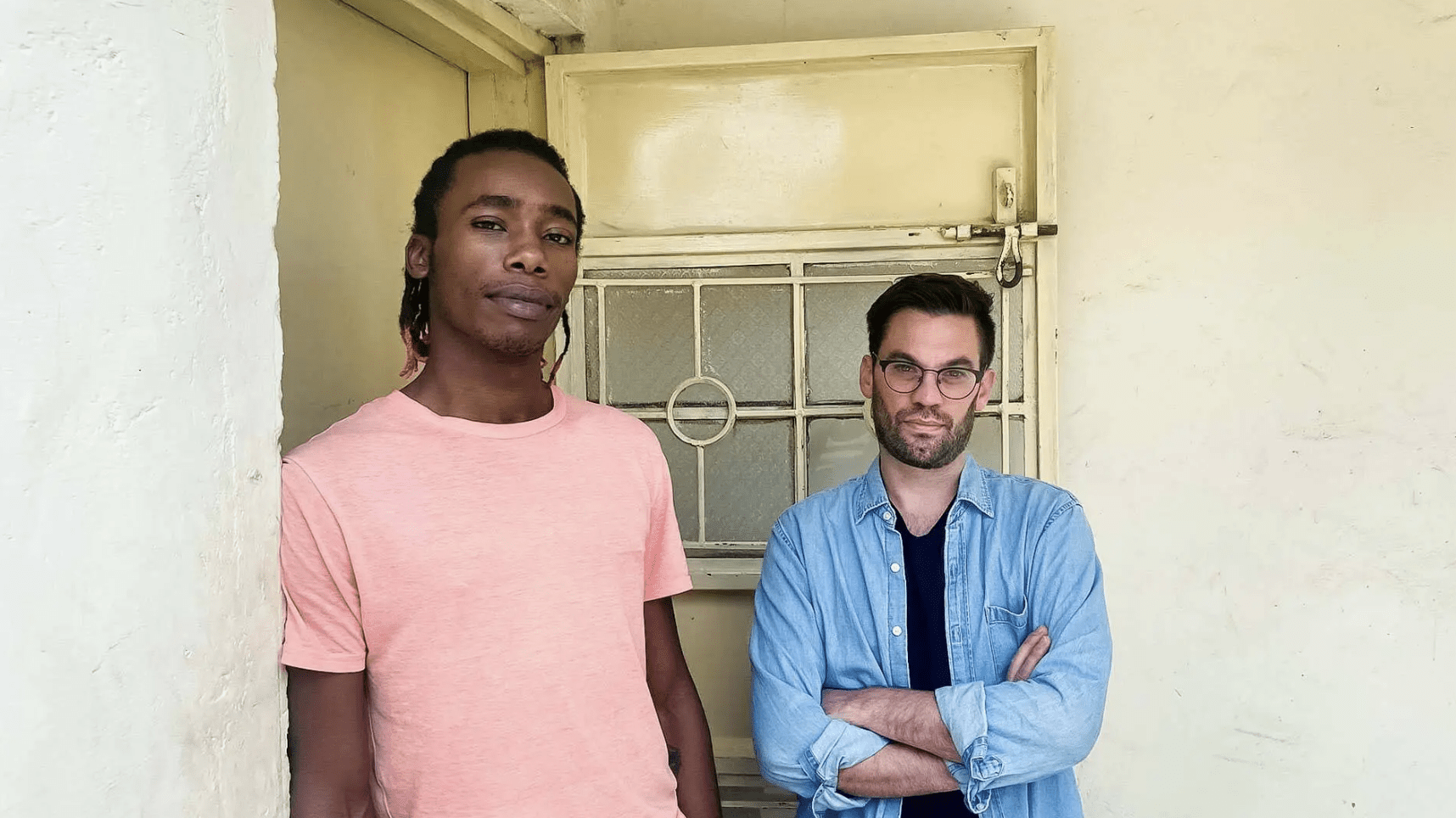  Matthew Thomann (right), an assistant professor of anthropology, and research assistant John Maina (left) stand outside the recovery center in Nairobi, Kenya.
