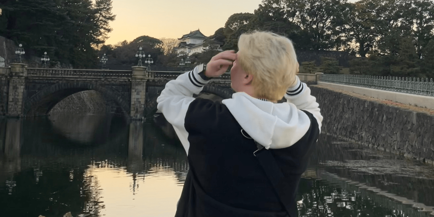 Jack Burke stands overlooking a canal. His back is to the camera.