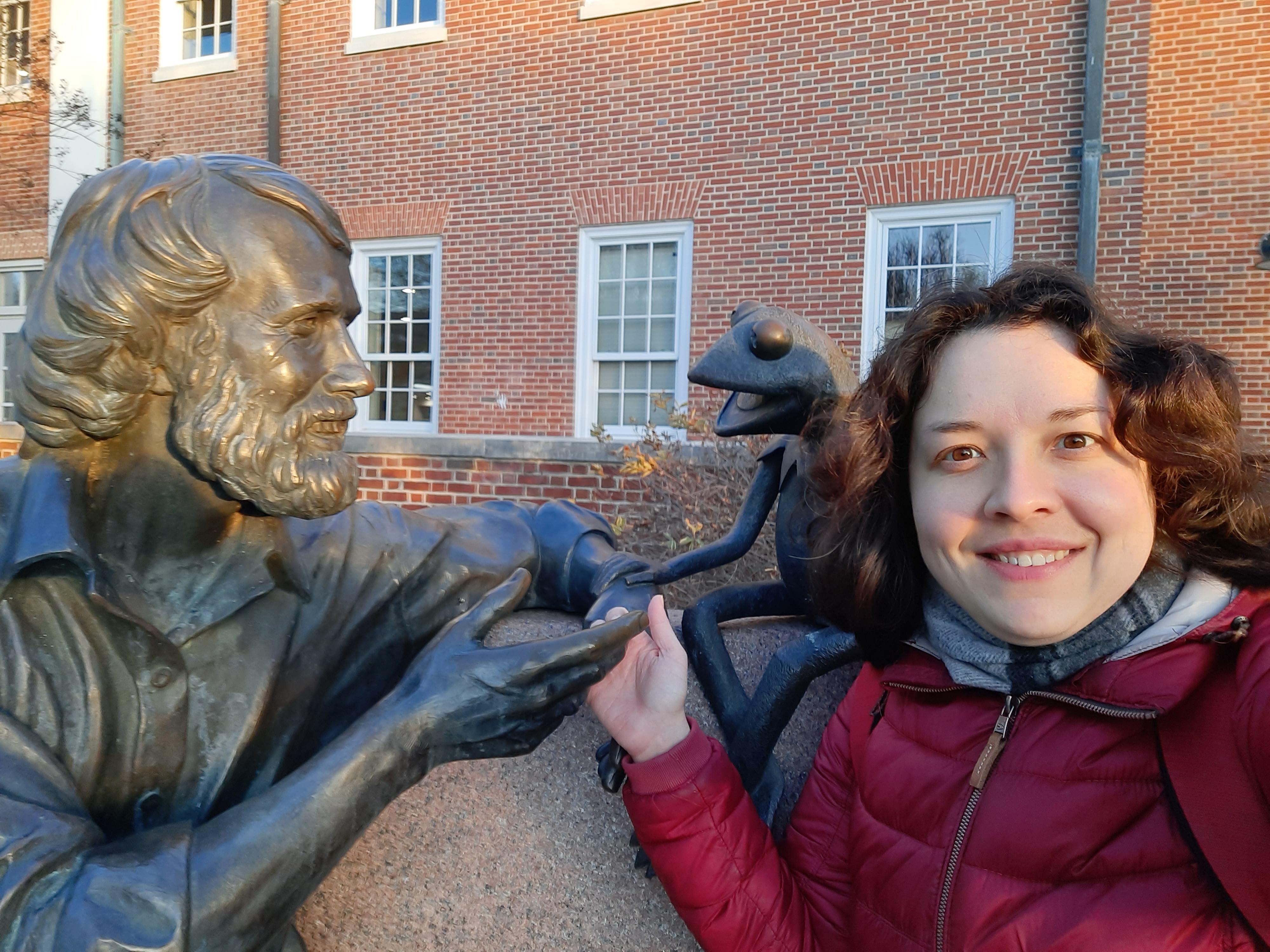 Visiting Fulbright scholar Dr. Elvira Barkhatova poses with the Jim Henson statue on UMD's campus.