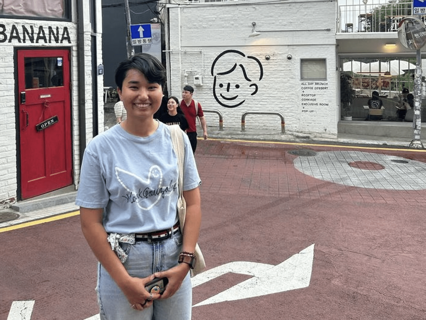 Elizabeth "Jwi" Brown poses on a street corner in Singapore. 