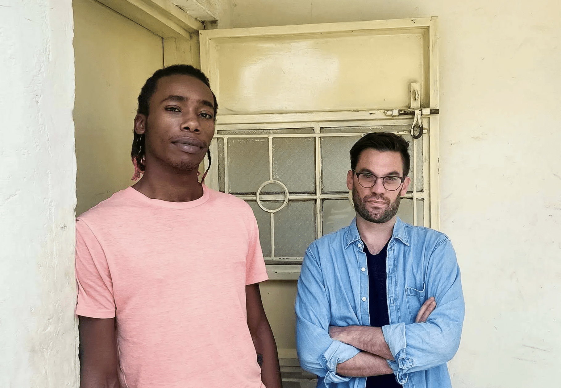 Matthew Thomann (right), an assistant professor of anthropology, and research assistant John Maina (left) stand outside a recovery center in Nairobi, Kenya.