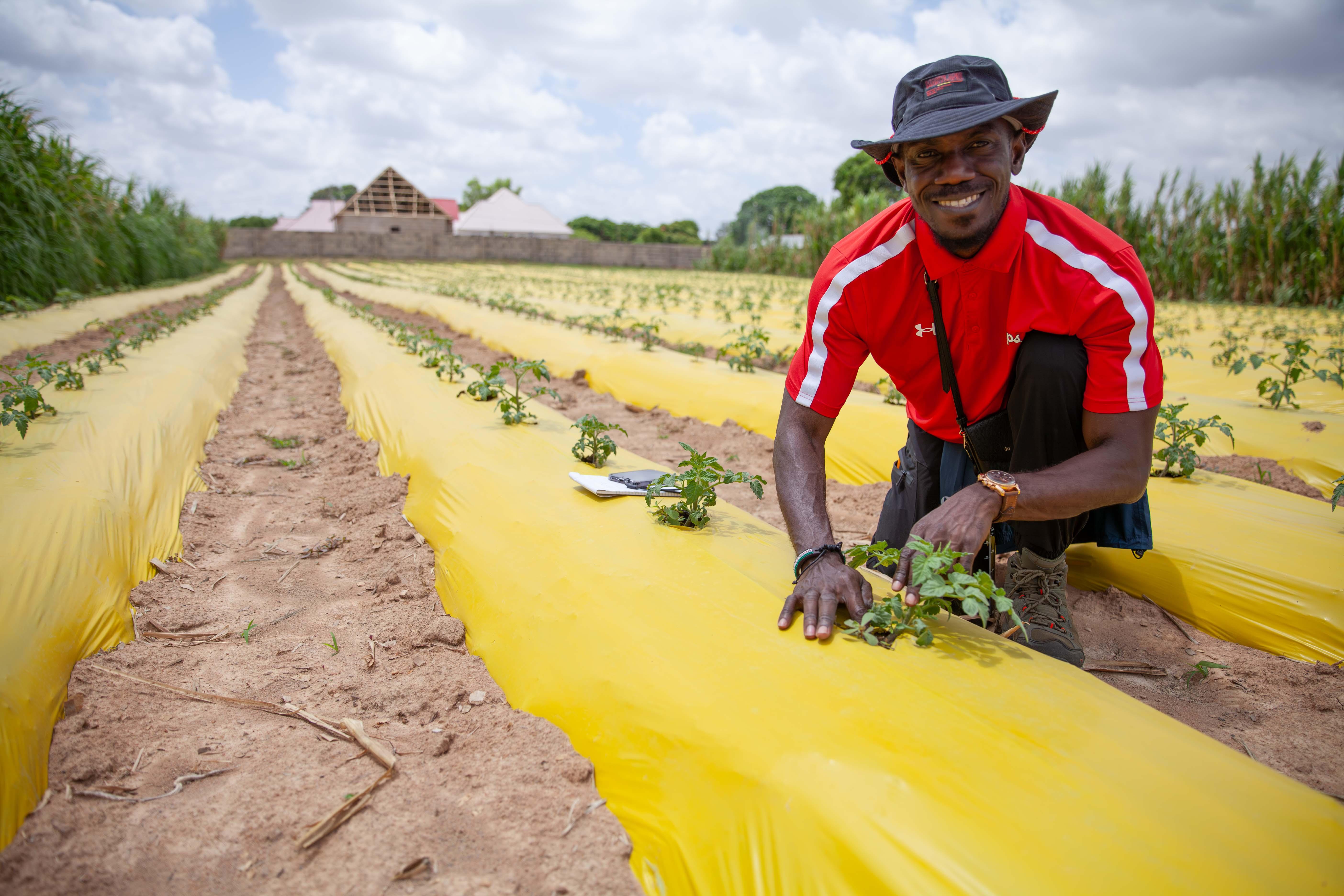 John Samura, Masters student in agricultural and extension education, checks out an innovative irrigation system at Cultivaid's demo farm in Dodoma, Tanzania.
