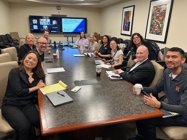 Attendees of the U21 HREx Symposium around a conference table