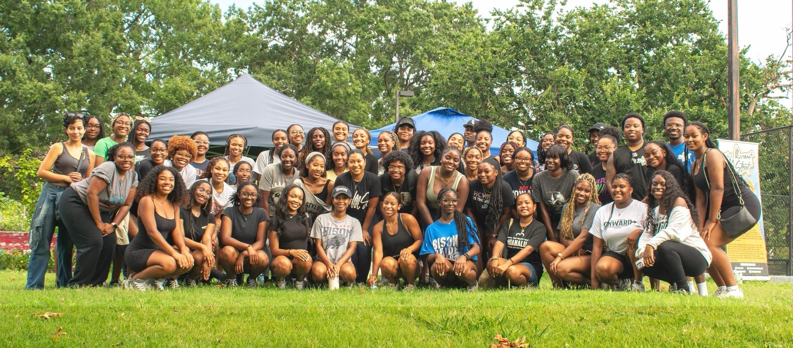 Large group of young community service volunteers in The Movement Street gather for a photo
