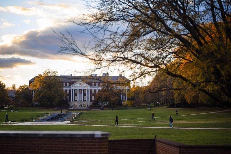 Students waking on the Mckeldin Mall on the UMD campus at sunset