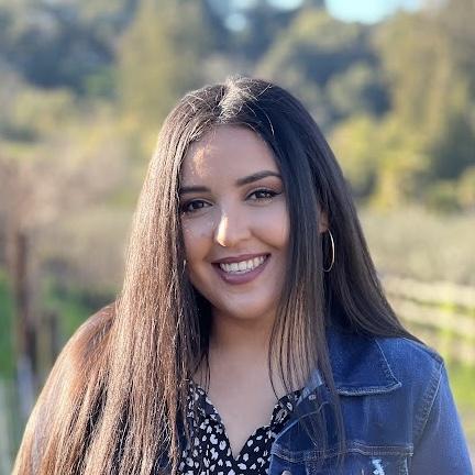 Aralia Ramirez smiles in a field