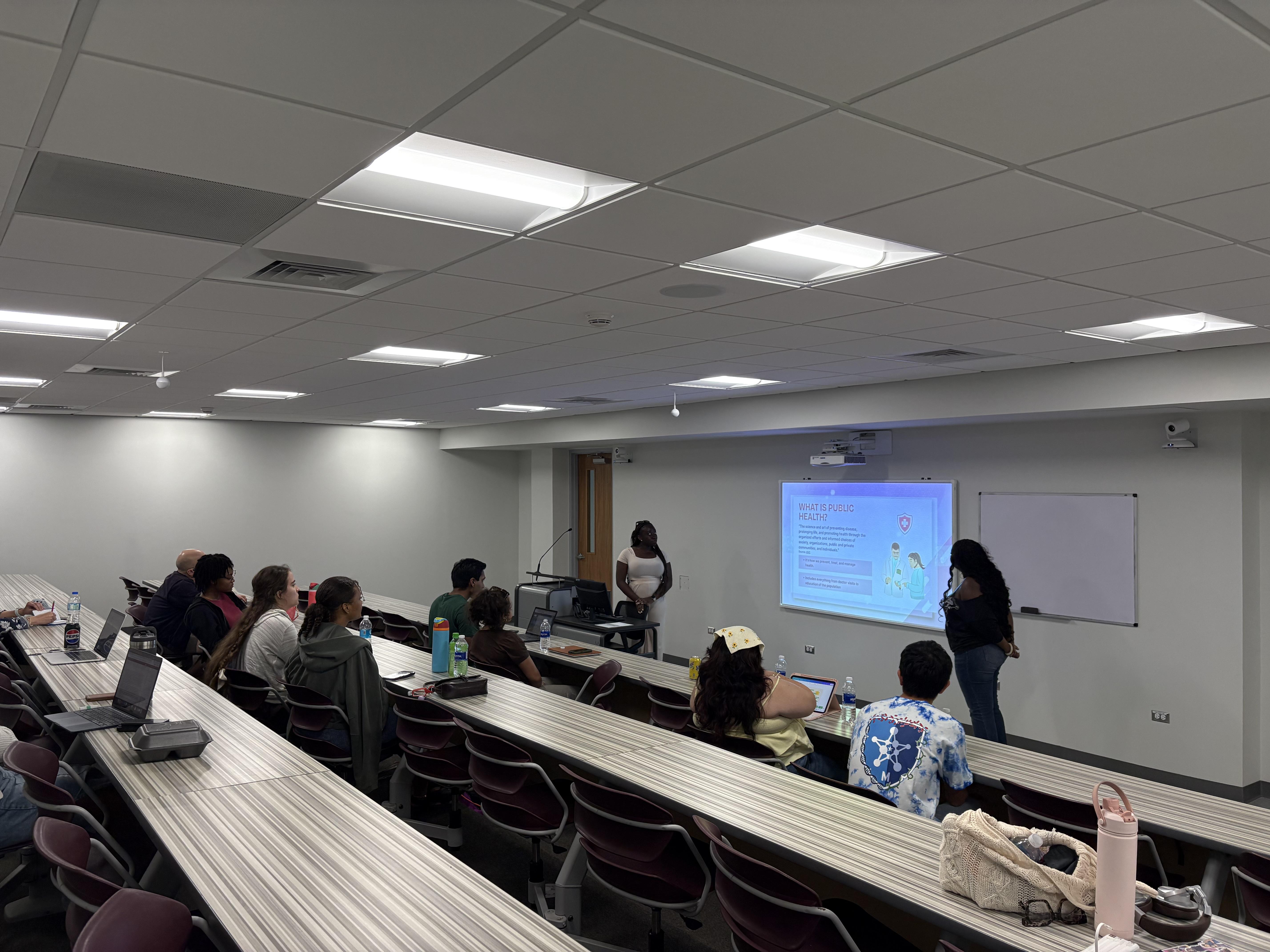 Students in a classroom facing presenter at the front