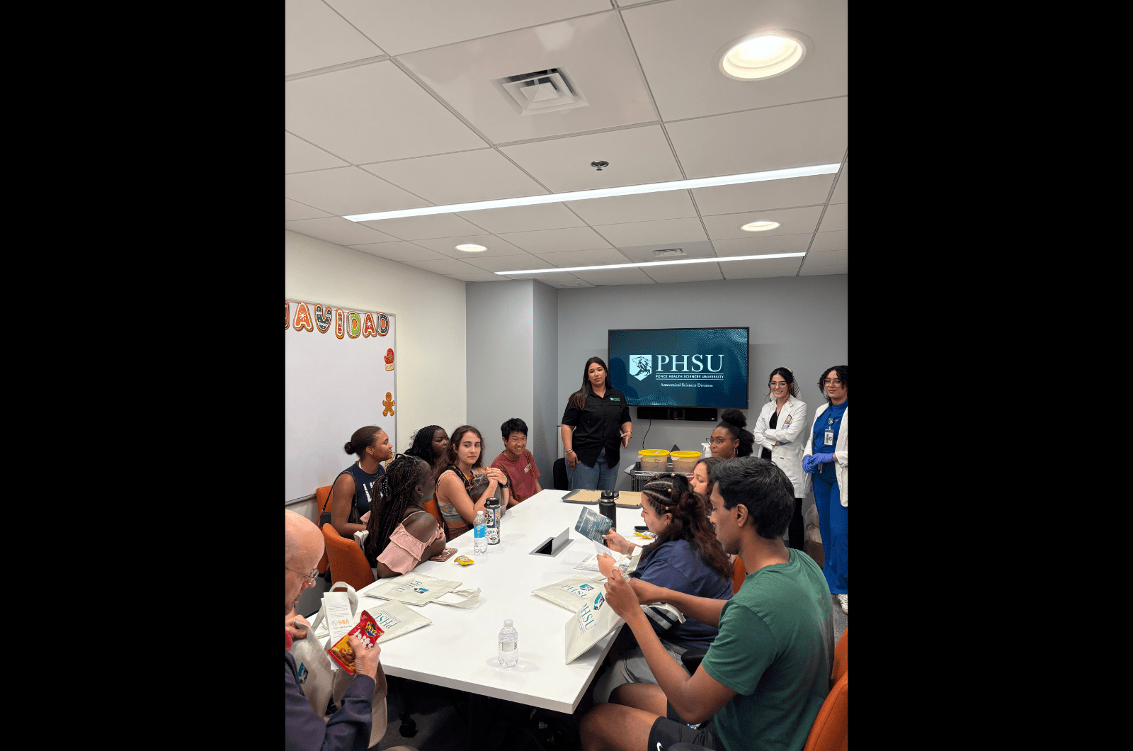 Students seated around a table in a conference room